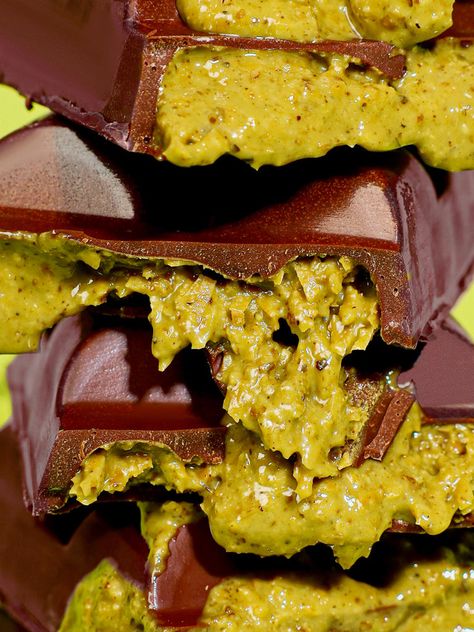 Close up of the Viral Dubai Chocolate bar showing its gooey pistachio butter and premium chocolate Viral Pistachio Chocolate Dubai, Stuffed Chocolate Bar, Dubai Chocolate Bar, Chocolate Bar Photography, Pistachio Filling, Disney Themed Food, Dubai Chocolate, Chocolate Photos, Milk Chocolate Bar