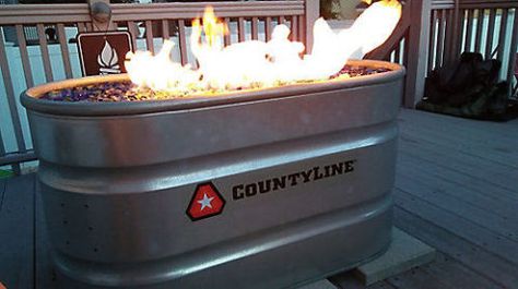 Put your DIY skills to the test with this natural-gas fire pit project.  Get the tutorial at Tractor Supply Co. Propane Tank Fire Pit Diy, Stock Tank Fire Pit, Winery Decorations, Backyard Extension, Diy Propane Fire Pit, Backyard Fountain, Diy Stock Tank, Deck Bar, Galvanized Decor