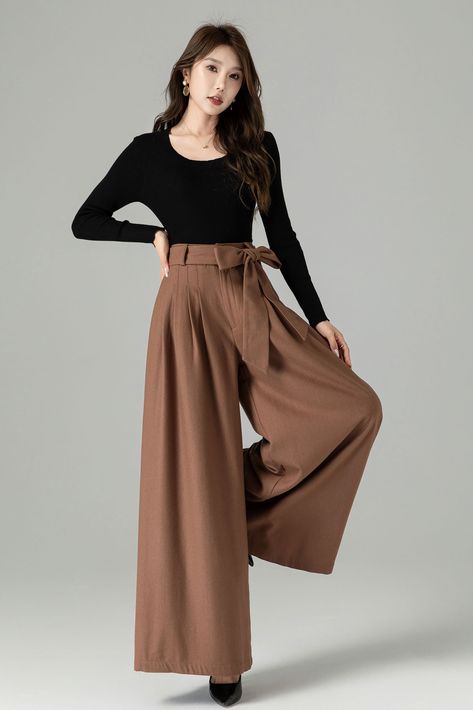 The wide-leg silhouette offers a flattering and timeless fit, while the high-quality fabric ensures warmth and softness. These versatile brown wool wide-leg pants can be dressed up with a blouse and heels for a polished office look or paired with a cozy sweater and boots for a chic and comfortable ensemble.  DETAIL * 30% wool, 30% fiber, 40% polyester * Has no Polyester Lining * Seam pocket * Front zipper and buttons closure * Skirt pants, wide leg pants, Pleated pants * Perfect forSpring, autum Bodysuit Wide Leg Pants, Pants For Autumn, Long Sleeve Pants Outfit, Modest Fashion Outfits Pants, High Waisted Fashion, Palazzo Pant Outfit, Winter Outfits With Pants, Brown Pleated Pants Outfit, Brown Palazzo Pants Outfit