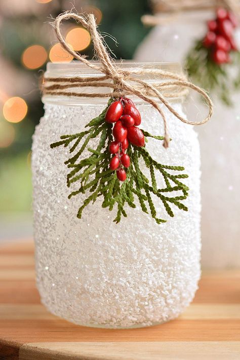 These DIY snowy mason jars made with glitter and epsom salt are SO PRETTY and they're really easy to make! A perfect Christmas craft that you can display all winter long. These mason jar luminaries are a great holiday project - and they only take 15 minutes to make! Snowflake Mason Jars, Stain Mason Jars Diy Glass Paint, Snowman Luminary Jar, Mason Jar Glitter Diy, Mason Jar Repurpose, Ball Jars Ideas Diy Projects, Epsom Salt Christmas Decor, Epsom Salt Mason Jars, Glass Jar Crafts Christmas Diy Projects