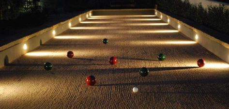 Install lights on the terrain. Put in drainage pipes. Light the trees on the outside too for beauty. Use LEDs or solar-powered lights. Bocce Court Backyard, Court Pictures, Outdoor Movies, Bocce Ball Court, Bocce Court, Bocce Ball, Koi Fish Pond, Sport Court, Yard Games