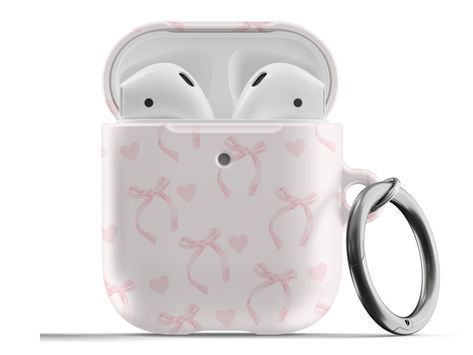 𝗗𝗘𝗦𝗖𝗥𝗜𝗣𝗧𝗜𝗢𝗡: Protect your AirPods with our Pink Ribbon Bows Hearts Coquette AirPods Case! This cute AirPods case features light pink bows and hearts on a pink background. ∙ Impact absorbing & scratch resistant case  ∙ Wireless charging compatible ∙ Glossy or matte finish ∙ 3-piece design ∙ Slim and lightweight ∙ Precisely aligned port openings ∙ Includes a metal carabiner ∙ Printed in the USA ∙ 360o protection from bumps, drops, and scratches Important note: Our AirPods Pro Case cover Cute Aesthetic Airpod Cases, Cute Pink Airpods Case, Pink Airpods Aesthetic, Bow Airpod Case, Coquette Airpod Case, Airpods With Case, Pink Airpod Case, Pink Airpods Case, Cute Airpod Cases