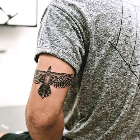 100 Striking Eagle Tattoo Designs for 2022 - The Trend Spotter Eagle Tattoo Back Of Arm, Eagle Tricep Tattoo, Cool Tricep Tattoos For Men, Eagle Tattoo Tricep, Men Tricep Tattoo Ideas, Tattoo Ideas Tricep, Born To Love Tattoo, Tattoo Eagle Arm, Eagle Tattoo Ideas For Men