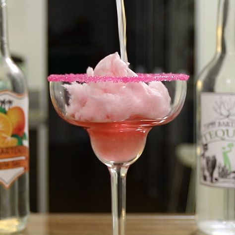 If putting cotton candy in a cocktail is a crime, get ready to be a dang criminal 'cause this Cotton Candy Margarita is so spectacular, it's worth breaking the normal laws of the cocktail arts. This tasty dessert drink mixes up tequila, Triple Sec, lime juice, cream soda, and pink cotton candy for a really delicious flavor profile, plus a little show when you pour the booze over the cotton candy! Cotton Candy Margarita, Tequila Drinks Recipes, Cotton Candy Cocktail, Best Margarita Recipe, Flavored Margaritas, Creamy Cocktails, Candy Cocktails, Candy Drinks, Tipsy Bartender