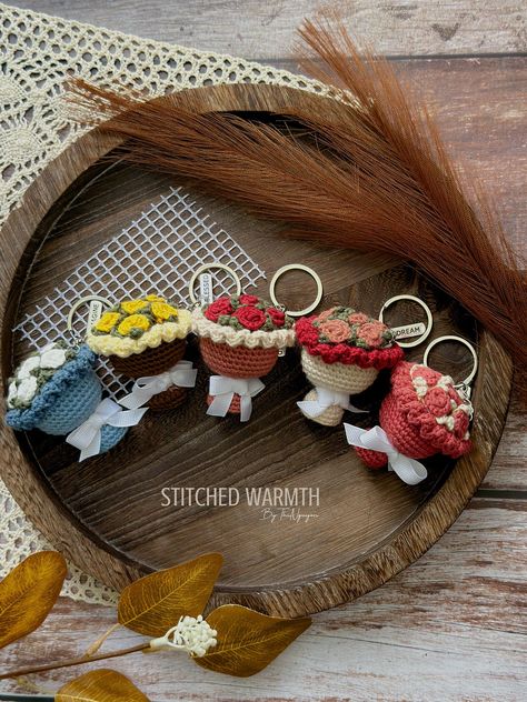 This crocheted flower bouquet keychain is the perfect way to add a touch of springtime joy to your keys. With its bright colors and cheerful blooms, it's sure to put a smile on your face every time you see.#crochetkeychain #handmadegifts #DIYkeychain #crochetlove #keychainaddict Croche Keychains, Crochet Flower Bouquet Keychain, Crochet Flowers Keychain, Cute Crochet Charms, Crochet Keychain Ideas Gifts, Bag Charms Crochet, Crochet Gift Ideas For Friends, Crocheted Flower Bouquet, Crochet Cute Keychain