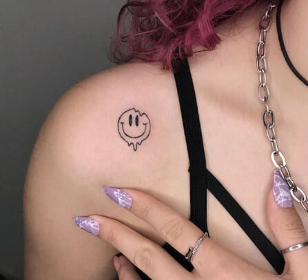 Drippy Smiley Shoulder Tattoos For Women Melty Smiley Face Tattoo, Smiley Hand Tattoo, Semi-colon Smiley Face Tattoo, Droopy Smiley Face Tattoo, Smiley Face Flower Tattoo, Happy Tattoos For Women, Drippy Smiley Face Tattoo, Melting Face Tattoo, Smiley Tattoo Design