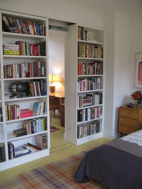 clever sliding bookcases (i love secret rooms) via dwell Gömda Rum, Hidden Door Bookcase, Bookshelf Room Divider, Hidden Room, Bookshelf Door, Lots Of Books, Bookcase Door, Hidden Rooms, Secret Door