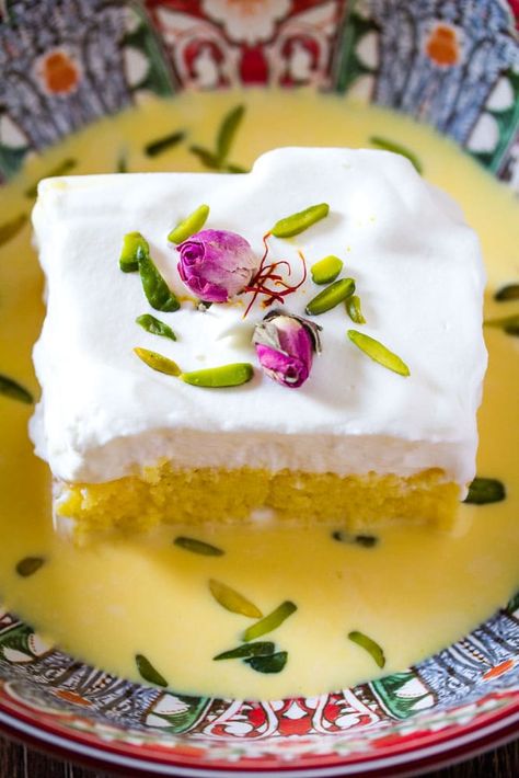 Saffron Milk Cake in a red bowl with rose buds and slivered pistachios Saffron Milk Cake, Milk Cake Recipe, Saffron Milk, Saffron Cake, Persian Desserts, Middle Eastern Desserts, Tandoori Masala, Milk Cake, Tres Leches Cake