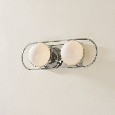 Opal glass spheres are held in gem-like settings, bringing a modern jewelry aesthetic to the bath or powder room. The two-, three-, and four-light options are displayed within an elegant metal racetrack frame and can be mounted vertically or horizontally making them perfect solo above a mirror or in pairs alongside it. Finish: Polished Nickel | Hudson Valley Lighting Amy 2 Light Bath & Vanity 5.5 H x 16.0 W x 5.25 D in gray in Polished Nickel | 5.5" H X 16" W X 5.25" D | Wayfair Nickel Mirror, Mid Century Bathroom Light, Bathroom Lighting Next To Mirror, Above Mirror Vanity Lighting, Bathroom Vanity Light, Vanity Light, Bathroom Mirror Sconces, Polished Nickel Bathroom Fixtures, Above Mirror Bathroom Lighting