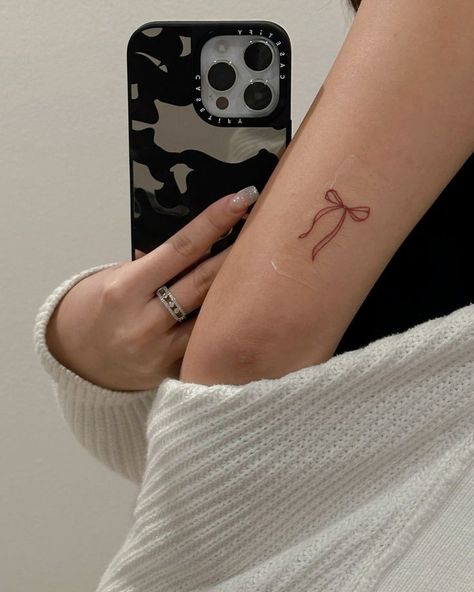 Small Tattoo Ideas Back Of Arm, Small Arms Tattoos, Dainty Ribbon Tattoo, Bow Arm Tattoo, Ribbon Tattoos Bow, Tiny Bow Tattoo, Little Bow Tattoo, Small Tattoos On Arm, Small Back Tattoos For Women