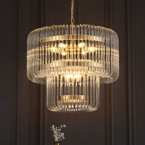 The stunningly elegant ceiling light is crafted from brass gold metal and two cascading layers of curved glass tubes. A modern glam lamp that embellishes any room while giving off an ambient glow. Its frame, a modern marvel, is hugged by transparent glass loops that cascade light across your space, creating a warm, inviting ambiance that’s both chic and cheerful. This Chandelier is a grand scale statement piece with125 curving rods seemingly suspended around tiered rings of brushed brass. As the Closet Chandelier Walk In, Modern Living Room Chandelier, Chandelier With Fan, Closet Chandelier, Glam Lamps, Metal Belts, Modern Contemporary Chandelier, Chandelier Designs, Crystal Chandeliers For Living Room