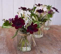 wedding jam jar flowers Jam Jar Flowers, Autumn Wedding Flowers, Mason Jar Flower Arrangements, Christmas Wedding Flowers, Jar Flowers, Chocolate Cosmos, Red Wedding Flowers, Jam Jars, Mason Jar Flowers