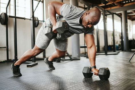 Dumbbell, fitness and bodybuilder black man with workout training in gym or garage studio for wellness, body goal and motivation. Power, strong and african sports man doing push up exercise with gear Dumbbell Workout Plan, Daily Stretching Routine, Full Body Stretch, Stretch Routine, Hamstring Stretch, Men's Health, Resistance Training, Men’s Health, Dumbbell Workout