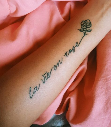 my first tattoo! la vie en rose @elysian.vibez La Vie En Rose Spine Tattoo, La Vie En Rose Tattoo Fonts, Zia Tattoo, Tattoo Lettering Design, Skeleton Hand Tattoos, Tattoos Inspo, Skeleton Hand Tattoo, Tattoo Font, Girly Tattoos