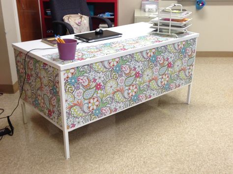 My desk at school this year! Wrapping paper + white duct tape + white contact paper = a whole new atmosphere for my room! Goodbye brown laminate and metal desk! Teacher Desk Skirt, Desk Skirt For Teacher Desk, Contact Paper Desk, Prek Desk Decals, Upcycled Teachers Desk, Contact Paper Desk Teacher, Metal Desk Makeover, School Clinic, Tattooed Teacher