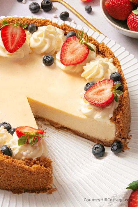 This homemade Philadelphia cheesecake recipe makes a super smooth, creamy cheesecake with a crunchy graham cracker crust. This step-by-step guide shows how to make a Philadelphia cream cheese cheesecake, plus plenty of tips and tricks to bake the best Philly cheesecake. Serve with your favorite toppings such as blueberry sauce, cherry topping, hot fudge sauce, lemon curd, or caramel sauce and fresh fruit. A wonderful make-ahead dessert for any occasion and holiday. | CountryHillCottage.com Philadelphia Cream Cheese Cheesecake Recipe, Philadelphia Cream Cheese Cheesecake, Smore Cheesecake, Philadelphia Cheesecake Recipe, Cheesecake Recipe No Water Bath, Unique Cheesecake Recipes, Philly Cheesecake, Lemon Cheesecake Recipe, Cream Cheese Recipes Dessert