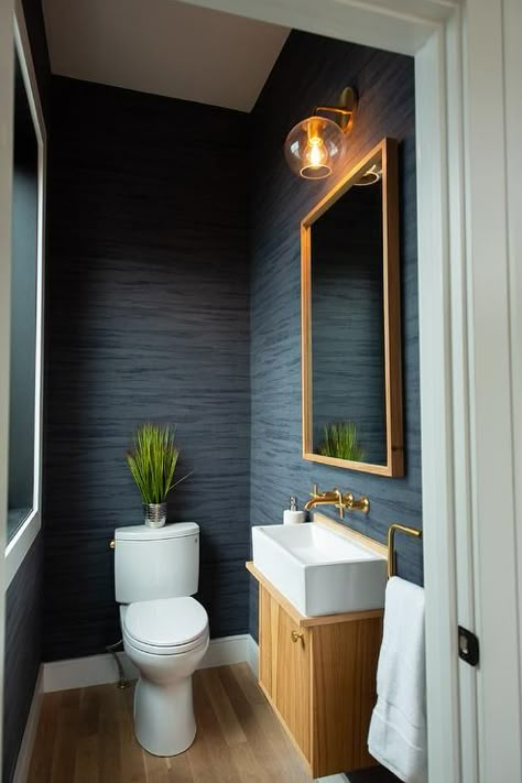 This navy blue bathroom screams sophistication with it's grass cloth looking vinyl walls and brass fixtures. Bathrooms Contemporary, Blue Powder Room, Gray Bathrooms, Marble Basketweave, Navy Blue Bathrooms, Light Oak Floors, Powder Room Remodel, Navy Bathroom, Modern White Bathroom