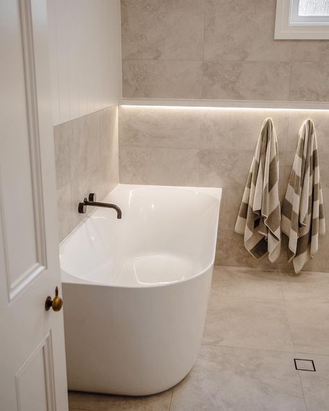 How incredible is this bathroom space by @NavyBoxConstructions?! Achieving the spa like feeling with the Posh Solus back-to-corner bath paired with the timeless white shaker style Kado Lux vanity. Contrasted by the Milli Pure tapware in brushed gunmetal with beige, textured tiles for a bright and inviting bathroom. 

Reece featured products 🛁 :
Milli Pure tapware, Milli Mood shower, Kado Lux vanity, Posh Solus back-to-corner freestanding bath. Shaker Style Bathroom Ideas, Brushed Gunmetal Bathroom, Light Beige Bathroom, White Beige Bathroom, White And Beige Bathroom, Gunmetal Tapware, Beige Bathroom Tile, Beige Tile Bathroom, Inviting Bathroom