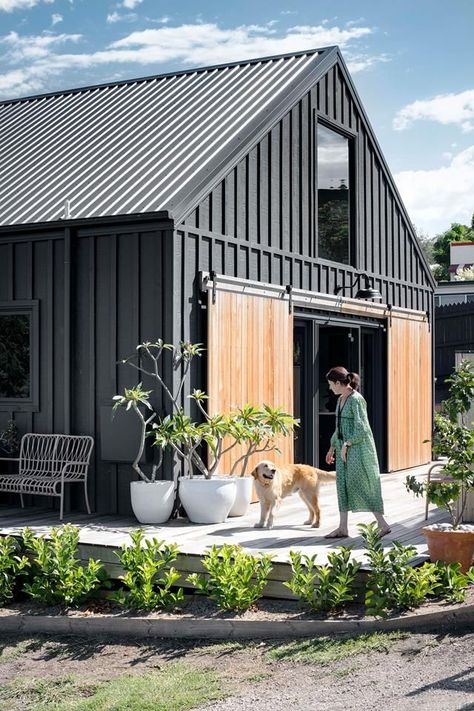 This modern barn style house exterior with timber barn doors was inspired by Nordic Noir homes. The house was built in just 10 weeks | Photography: Brigid Arnott | Styling: Hannah Brady Black Colorbond House, Black And Timber House, Easy Build House, Nordic Country Home, Wood Above Windows, Nordic House Exterior, Black Country House, Black And Wood House Exterior, Modern Barn House Interior