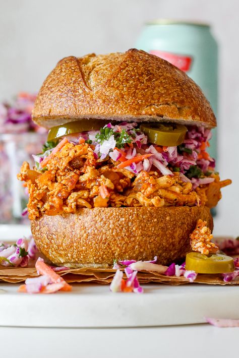 These BBQ Pulled Tofu Sandwiches with Creamy Kohlrabi Slaw are the ultimate summer sandwich! Saucy "pulled" tofu imitates chicken or pork remarkably well, and it's piled high on buns along with a light and creamy kohlrabi cabbage carrot slaw for an amazing summer meal that will elicit two thumbs up from vegetarians and omnivores alike. Pulled Pork Sandwhich, Cabbage Carrot Slaw, Vegan Pulled Pork Sandwich, Kohlrabi Slaw, Vegan Pulled Pork, Tofu Burger, Cabbage Carrot, Tofu Sandwich, Vegetarian Bbq