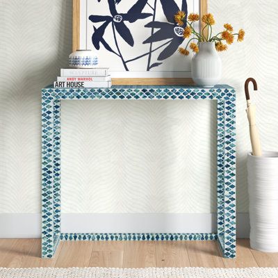 Greet guests in your entryway with this elegant and breezy console table. It showcases a beachy capiz shell inlay in soft, neutral hues for an artisanal vibe that's sure to complement your coastal space. The 35" wide frame is made from engineered wood, and it rests on a sled base for an open feel that keeps sightlines clear. We love that the surface accommodates everything from accent pieces and a vase of fresh flowers to a table lamp and a mail organizer. Plus, this table offers a lot of room u Moroccan Console Table, Living Room Side Table Decor Ideas, Small Entryway Table, Small Console Table, Entry Way Table, Console Table Decorating, Modern Console Tables, Capiz Shell, Modern Console