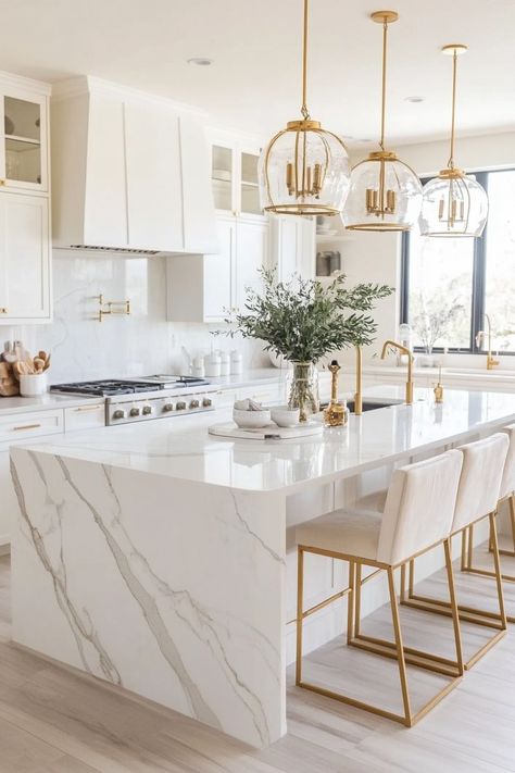 Discover the latest kitchen design featuring luxurious marble countertops and gold accents. This stunning combination enhances sophistication and brightness in any home. Perfect for a modern, chic look. #kitchendesign #homedecor #marbleinterior Coastal Luxury Interior Design, Airbnb Kitchen Ideas, Classy Kitchen Ideas, Waterfront Kitchen, Luxury Beach House Interior, Coastal Luxe Interiors, Luxury White Kitchen Design, Kitchen Garland, Modern Luxury Kitchen Design