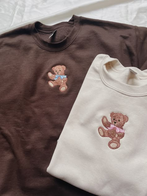 "Embroidered Teddy Bear Sweatshirt! -Embroidered on a cotton/polyester blend crewneck sweatshirt, this design is simple and minimalistic, perfect for every outfit! -Embroidery design measures 2.25\" x 3.5\". -See product pictures for shirt sizing chart. **SWEATSHIRTS ARE IN UNISEX SIZING AND RUN TRUE TO SIZE. -All sweatshirts are handmade on an embroidery machine so there may be slight differences, but we only sell the sweatshirts that meet our high-quality standards. -To maintain the quality of Teddy Bear Aesthetic Clothes, Crewneck Sweatshirt Embroidered, Back Of Sweatshirt Designs, Embroidery On A Sweatshirt, Cute Embroidery Designs Sweatshirts, Trending Embroidery Designs, Cute Tshirt Designs For Women, Machine Embroidered Clothes, Cute Embroidery Ideas Shirts