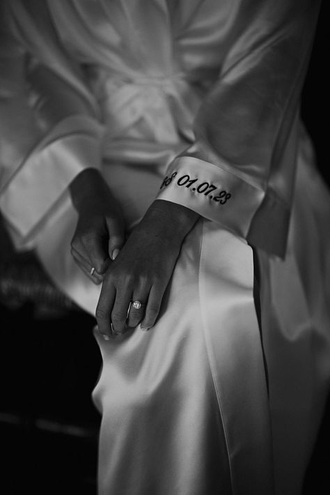 embroidered wedding date on the cuff of the brides satin getting ready robe Wedding Robes Getting Ready Satin, Wedding Morning Candle, Bridal Morning Photoshoot, Wedding Morning Aesthetic, Wedding Morning Photos, Wedding Detail Photography, Bridesmaid Robe Pictures, Bridal Getting Ready Photos, Bridal Getting Ready Room