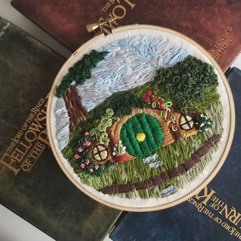 Have I mentioned that I've fallen in love with embroidery??? I honestly wasn't expecting to love it so much. I was curious and decided to give it a try. It is so fun! This Hobbit hole took about 10 hours. * * * * * * * #craftyfingers #needlework #needlepointersofinstagram #needlecrafts #needlecraft #embroideryfloss #embroiderydesign #freehandart #lotr #lordoftherings #thehobbit #hobbiton #tolkien #colorhunters #fiberart #fiberartist Hobbit House Embroidery, Hobbit Hole Embroidery, Lotr Embroidery Pattern, Hobbit Embroidery, Idea Embroidery, Embroidery Reference, Embroidery Things, Bridal Party Invitations, Middle Earth Art