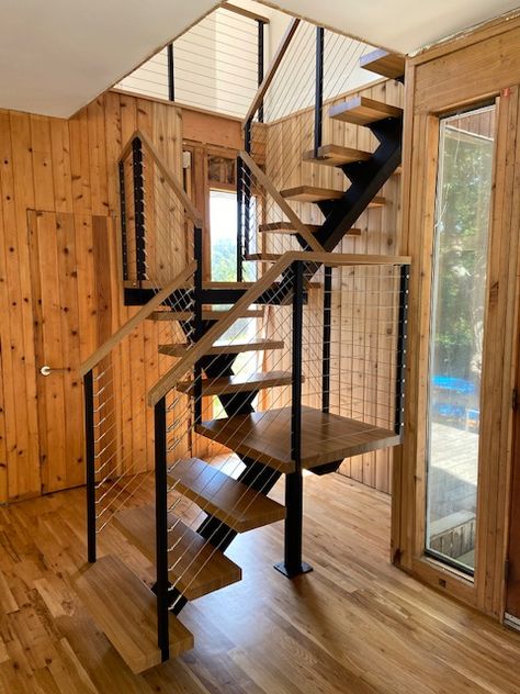 Designed for a tight space is this steel stringer switchback floating stairs with landings. Stairs With Landing Small Spaces, Staircase Ideas For Small House, Narrow Stairs Design, Space Saving Basement Stairs, Stair For Small House, Stair Design For Small Space, A Frame Staircase, Internal Stairs Small Space, Small Home Stairs Design