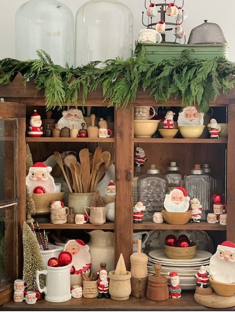 Vintage Santas In The Kitchen Vintage Santa Tablescape, My Weathered Home, Kitchen Hutch Christmas Decor, Vintage Santa Christmas Decor, Christmas Vintage Decor, Vintage Santa Decor, Vintage Christmas Vignettes, Santa Display Ideas, Santa Kitchen Decor