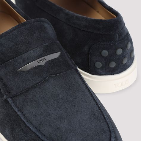 Tod's Blue Suede Loafers showcase exceptional craftsmanship with a round toe design and a luxurious blue suede upper. A leather strap and metal logo detail enhance the slip-on style, while a pristine white rubber sole with signature gommini details ensures both comfort and style. Ideal for enhancing any smart casual outfit.

- 100% suede upper  
- 100% rubber sole  
- Slip-on style  
- Back embossed logo Blue Suede Loafers, Suede Loafers, Strap Top, Blue Suede, Embossed Logo, Rubber Sole, Metallic Silver, Leather Straps, Silver Tone