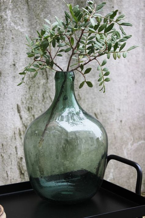 Antique demijohns' oversized scale and vintage charm bring a bit of drama to your decor. Find out how to decorate them as well as where to find them!--->#maisondecinq #antiques #antiquebottle #antiquedemijohn #frenchdemijohn #demijohn #frenchcountry #countryfrench #frenchfarmhouse #winebottle #antiquewinebottle #decoratingwithantiques #farmhousestyle #farmhousedecor Green Glass Bottles, Recycled Glass Bottles, Vintage Bottles, Green Vase, Deco Floral, Cool Ideas, Bottle Vase, Recycled Glass, Glass Decor