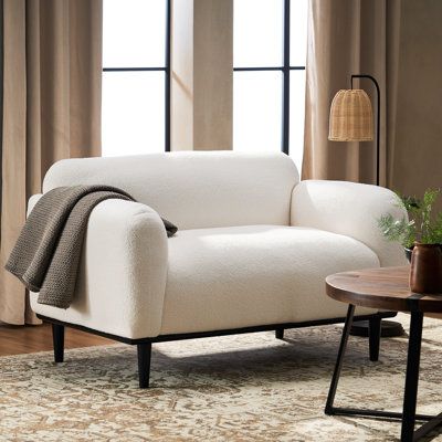 This loveseat's contemporary silhouette makes it an ideal addition to your den or living room. Crafted with a solid birch wood frame, it features a plush silhouette with round arms and a tight back filled with foam for an overstuffed look that invites you to lounge or read. It's balanced on four tapered dowel legs with a neutral finish and wrapped in polyester fabric for a tailored touch. Top perk: This sofa supports up to 600 lbs. and resists stains, so it holds up in busy homes. Fabric: White Contemporary Loveseat, Leather Loveseat, Swivel Armchair, Single Sofa, Sofa Sale, Loveseat Sofa, Modern Furniture Living Room, Modern Sofa, Platform Bed