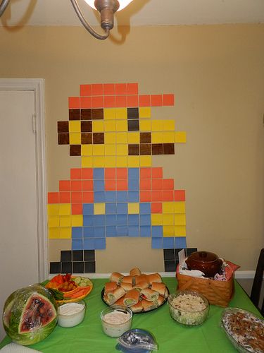 Bio Girl: Henry's Nintendo Land Birthday Party! NintendoLand 8 bit Mario out of post it notes Birthday Food Appetizers, Nintendo Decorations, Easy Mario Birthday Decorations, Easy Mario Decorations, Nintendo Decorations Party, Mario Table Centerpiece, Nintendo Party Decorations, Mario Decor, Mario Games For Birthday Party