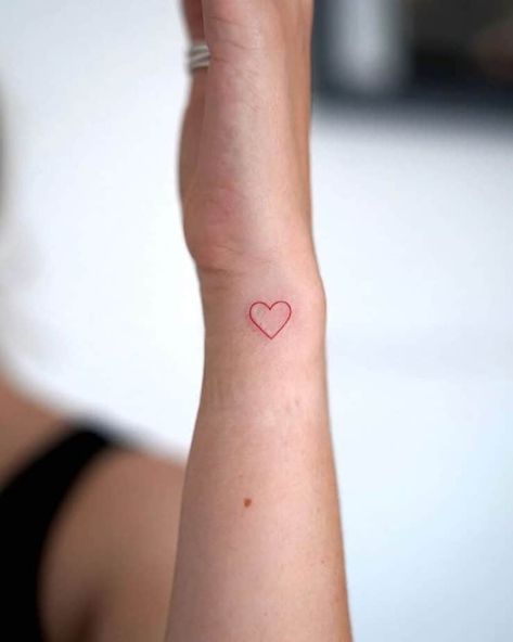 23. A red ink small heart hand tattoo Small Heart Outline Tattoo, Kissing Hand Tattoo, Hand Drawn Heart Tattoo, Small Heart Tattoo On Wrist, Heart Hands Tattoo, Small Red Ink Tattoo, Heart On Finger, Small Heart Wrist Tattoo, Heart Hand Tattoo