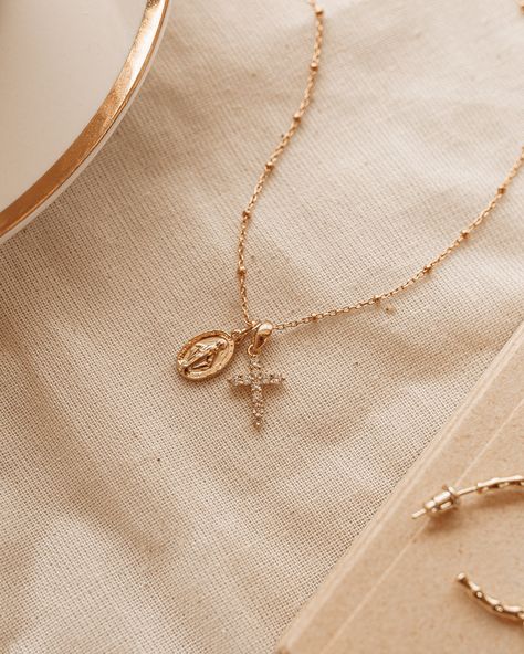 The Protégée Necklace means protected in French. This delicate charm necklace with Madonna and her cross are both iconic and beautiful, reminding you that you are protected. The Madonna pendent is gold plated silver 8x13.5mm and 2mm thick. Petite rhinestone cross features Cubic Zirconia on gold plated silver 10.5x15.5x2mm. Gold Filled chain 18 inches. Madonna Jewelry, Cross Necklace Women, Cross Jewelry Necklace, Parisian Wedding, The Madonna, Christian Necklace, Catholic Jewelry, Rhinestone Cross, Jewelry Accessories Ideas