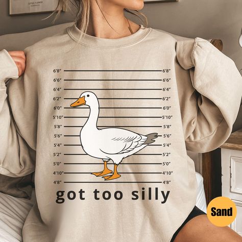 Silly Goose Sweatshirt | Got Too Silly Sweatshirt | Goose Crewneck | Silly Goose Sweatshirt | Funny Sweatshirt Gift | Gift For Him Matching T-Shirt: https://printworkshopcompany.etsy.com/listing/1789038227/silly-goose-comfort-colors-shirt-got-too ** HOW TO ORDER 1. Check our photos for sizing and color options.  2. Select your size and color from the drop-down menus.  3. Click "ADD TO CART" to add the shirt to your cart. 4. Click "PROCEED TO CHECKOUT" to purchase your sweatshirt. ** VIP Email Li Cute Funny Sweatshirts, Funny Crewneck Sweatshirt, Funny Sweatshirts For Women, Goose Quotes, Got Too Silly, Goose Sweatshirt, Too Silly, Goose Design, Silly Clothes