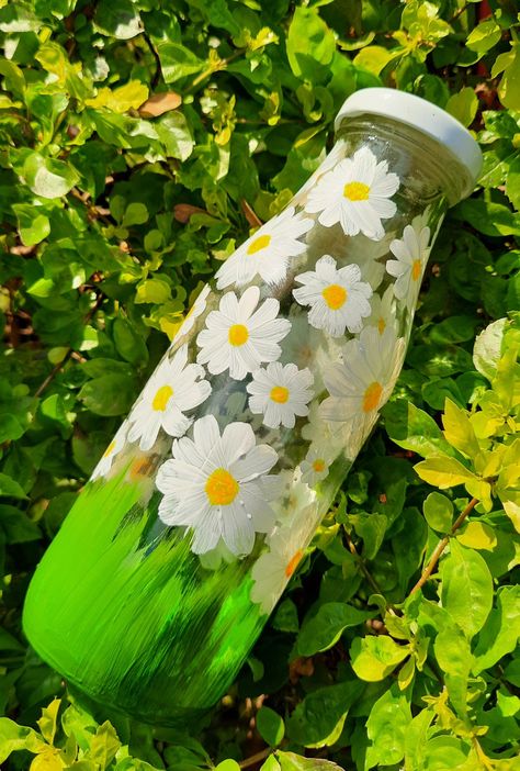 Daisies painted on a glass bottle using Acrylic paints Upcycling, Acrylic Paint On Glass Bottles, Acrylic Painting On Bottles, Water Bottle Decorating Ideas, Painting On Water Bottles, Glass Jar Painting Designs, Painting Ideas On Glass Bottles, Glass Bottle Painting Aesthetic, Bottle Art With Acrylic Paint