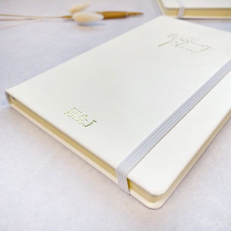 Personalised A5 'Wedding Plans' notebook, luxurious white vegan leather journal. A perfect engagement gift for a Bride-To-Be or newly engaged couple, customise with initials or a monogram.  Lined A5 notebook, foil blocked by hand with a 'Wedding Plans' design, personalised with the initials/monogram of your choice.  * A5 white vegan leather notebook * Cream lined paper  * 80 sheets/160 pages of 80gsm paper  * White elastic closure  * Light grey ribbon page marker  A5 in size, they are perfect to Couple Monogram Design, Initials Wedding Invitation, Notebook Wedding, Engagement Gifts For Bride, Perfect Engagement Gifts, Couples Monogram, Wedding Logo Monogram, Engagement Gifts For Her, Wedding Logo Design