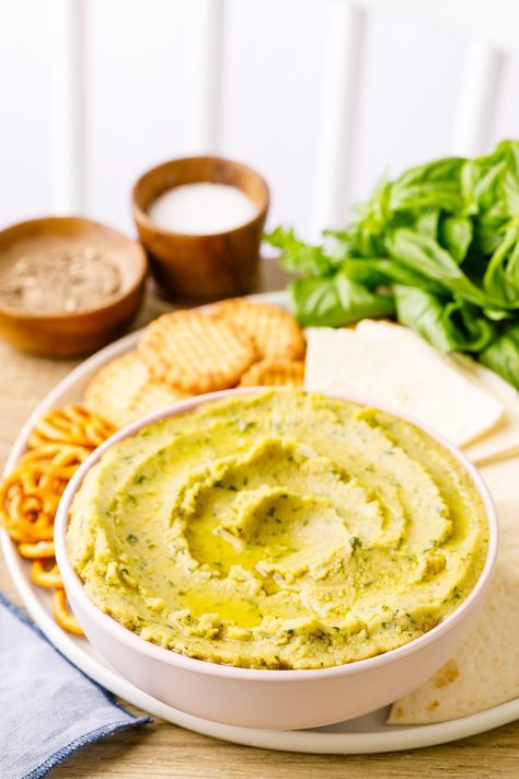 Basil Pesto Hummus - Nurtured Homes Basil Pesto Hummus, Basil Hummus, Pesto Hummus, Tomato Basil Chicken, Hummus Ingredients, Flavored Olive Oil, Jalapeno Recipes, Basil Recipes, Basil Chicken