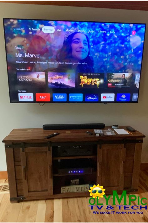 55 inch TV mounted with a flat-tilt mount above open wooden entertainment center with soundbar and surround sound.  For further streaming education about the different apps displayed visit https://olympictvandtech.wordpress.com/category/streaming-alternatives-to-cable/ 55 Inch Tv, Tv Mounted, School Products, Under Tv, Home Cinema Room, Tv Mount, Cinema Room, Twitter Quotes Funny, Mounted Tv