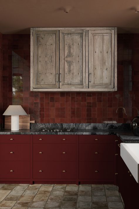 Rustic meets modern in this bold kitchen design! The deep burgundy cabinetry contrasts beautifully with the raw, reclaimed wood upper cabinets, giving the space a warm, inviting feel. Paired with black marble countertops and handmade terracotta tiles, the combination of textures brings elegance and charm to this space. Minimal brass hardware and a contemporary table lamp add subtle sophistication. Ideal for those who love a blend of rustic, modern, and timeless styles Oxblood Kitchen Cabinets, Wood Upper Cabinets, Burgundy Kitchen Cabinets, Dark Red Kitchen, Maroon Kitchen, Burgundy Kitchen, Black Marble Countertops, Burgundy Marble, Terracotta Kitchen