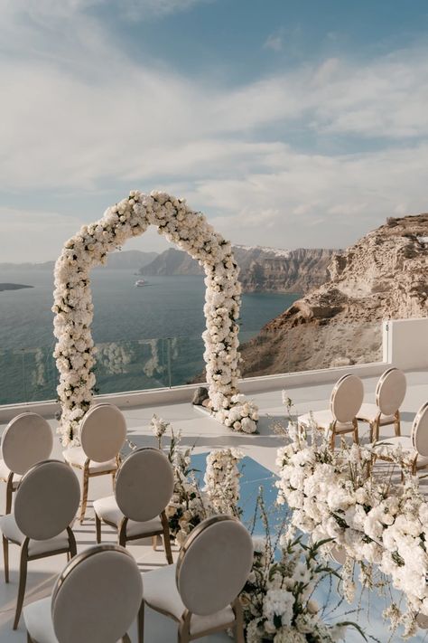 A white sunset micro-wedding with macro luxury details in Santorini Wedding Aisle Mirror, White And Off White Wedding, Beach Wedding Candle Aisle, White Rose Walkway Wedding, Oceanfront Wedding Ceremony, Beach Wedding Walkway, Mirrored Isle, Beach Front Wedding Ceremony, Wedding Ceremony Arch Ideas