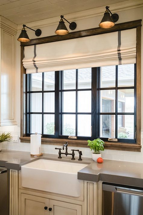 Black Kitchen Window. Kitchen features a black window above sink and three wall sconces. #kitchen #blackwindow #kitchenwindow #blackkitchenwindow Alicia Zupanblack-kitchen-window London Shades, Black Window Trims, Farmhouse Kitchen Curtains, Materials Board, Farmhouse Window Treatments, Mom Kitchen, Sink Decor, Herringbone Backsplash, Kitchen Lights