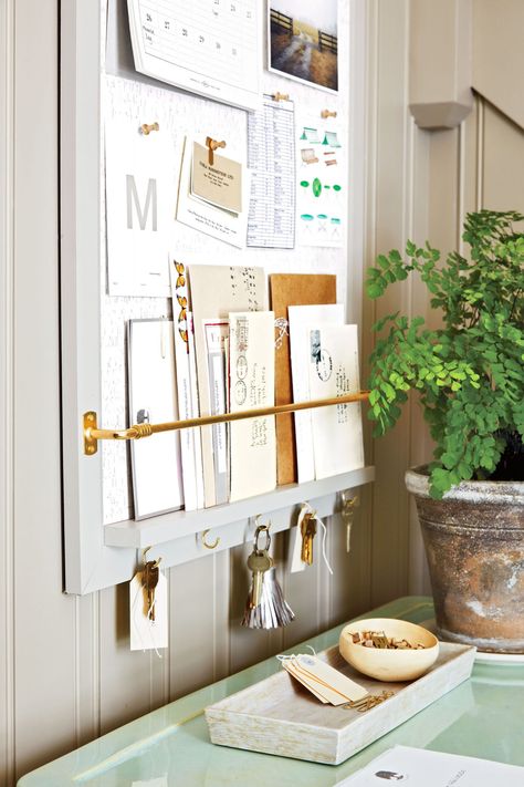 Entryway command center: Paint a corkboard to blend into the wall. Add a ledge and a curtain rod to display mail. Screw in cup hooks to hold keys. | marthastewart.com Martha Stewart Organizing, Command Center Kitchen, Home Command Center, Space Saving Bathroom, Family Command Center, Paper Clutter, How To Fold Towels, Memo Boards, Entryway Organization