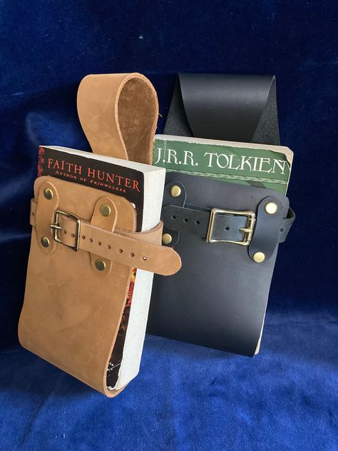 Book Holster for wearing book on belt, made of genuine leather scraps, leather belt holder for book. Renfaire, Cosplay, Renaissance faire Renfest, adjustable from standard paperback to trade (taller) paperbacks. (belt not included) ** for larger books see the listing link at the bottom of this Fits standard paper back books up to 9 inches tall And 16 inches in circumference. (Regular paperbacks and trade (taller) paperbacks , even the thick ones. I make these out of scraps from my leather straps Book Holster, Holster Belt, Leather Book Covers, Leather Scrap, Ren Fair, Belt Holder, Book Holder, Leather Book, Leather Scraps