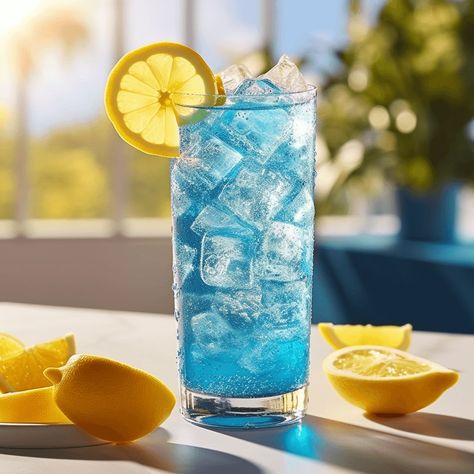 The Blue Lagoon Mocktail has a refreshing, sweet, and slightly tangy taste. The combination of lemonade, blue curaçao syrup, and lime juice creates a perfect balance of flavors, making it a light and enjoyable drink. Blue Lemonade Aesthetic, Blue Lagoon Drink, Blue Lagoon Mocktail, Random Prompts, Curacao Drink, Lemonade Flavors, Pina Colada Mocktail, Blue Lagoon Cocktail, Poolside Cocktails