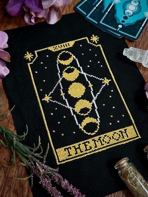 Channel lunar power with this moon phase cross stitch featuring an original moon tarot card design. This moon cross stitch is loaded with dark academia and witchy vibes! This listing is for a digital PDF pattern, not a complete cross stitch. Stitch Size: 65x96 Fabric: Black 16 CT Aida Dimensions: 4.1 in x 6 in Color Count (DMC): 2 ★The thread colors listed are just suggestions. Feel free to substitute with other colors as desired. ★Recommends 2 strands for stitching, but feel free to use more strands depending on coverage preferences. PDF Pattern Includes: ★Cover page with information ★1 Full size page of symbols on color (awesome for screen use) ★4 pages of enlarged symbols on color ★1 page thread color recommendations with other suggestions Black and white patterns can be provided on req Tarot Cross Stitch, Witchy Cross Stitch, Partner Tattoo, Geeky Cross Stitch Patterns, Moon Cross Stitch Pattern, Geeky Cross Stitch, Witch Cross Stitch, Moon Tarot Card, The Moon Tarot Card