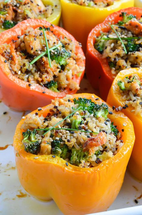 This dinner recipe is healthy, flavorful and satisfying. Salmon and Quinoa Stuffed Peppers make a nutritious meal! Sweet bell peppers stuffed with salmon, brown rice, quinoa, broccoli and a spicy Asian sauce. Salmon And Quinoa, Salmon Brown Rice, Bell Peppers Stuffed, Brown Rice Cooking, Low Carb Stuffed Peppers, Quinoa Broccoli, Quinoa Stuffed Peppers, Bell Pepper Recipes, Sweet Bell Peppers